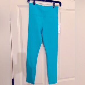 NWT - Athleta women’s Elation legging in turquoise.  Size Medium.  High waisted.